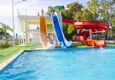 a water park with a water slide in a pool at Laguna Park Apartments in Sosúa