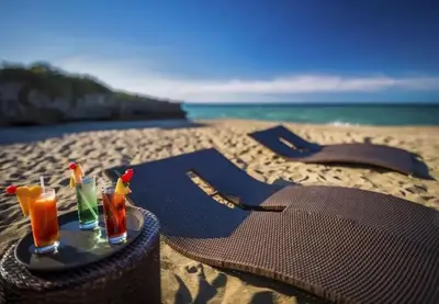 a table with two drinks on the beach at Laguna Park Apartments in Sosúa