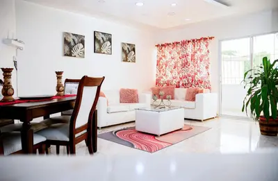 a living room with a piano and a table at Apartamento en el malecón cerca de la playa in San Felipe de Puerto Plata