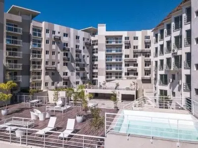 a large building with a swimming pool in front of it at Apartment5Start in Santo Domingo
