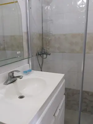 a bathroom with a white sink and a shower at Apartaestudio en el malecón y cerca de playas in San Felipe de Puerto Plata