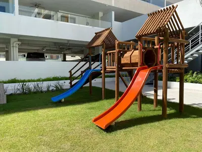 a playground with a slide on the grass at Luxury Beachside Retreat & Private Plunge Pool in Punta Cana