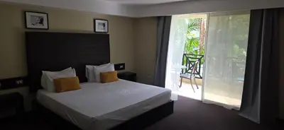 a bedroom with a bed and a sliding glass door at LTH Las Terrenas Hotel in Las Terrenas