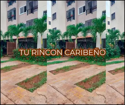 a hotel sign in front of a building at Tu rincon Caribeño in San Isidro