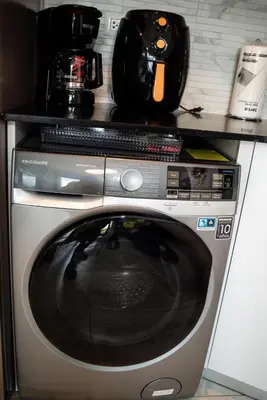 a microwave sitting on top of a washing machine at Ocean Blue at Cana Rock Star in Punta Cana
