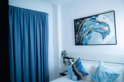 a living room with a blue curtain and a couch at Ocean Blue at Cana Rock Star in Punta Cana