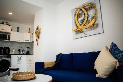 a blue couch in a living room with a rope on the wall at Ocean Blue at Cana Rock Star in Punta Cana