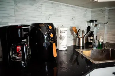 a kitchen counter with a coffee maker and a sink at Ocean Blue at Cana Rock Star in Punta Cana