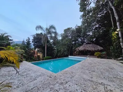a swimming pool in the middle of a resort at Teonil in Jarabacoa
