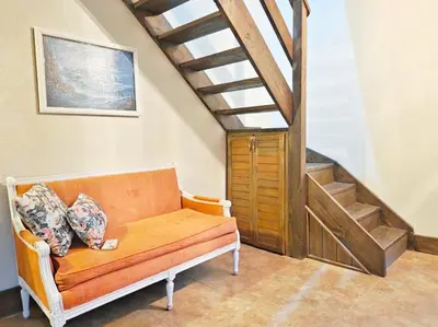a living room with a couch and a staircase at Teonil in Jarabacoa