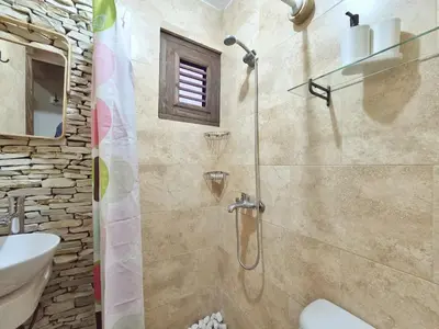 a bathroom with a shower and a toilet and a sink at Teonil in Jarabacoa