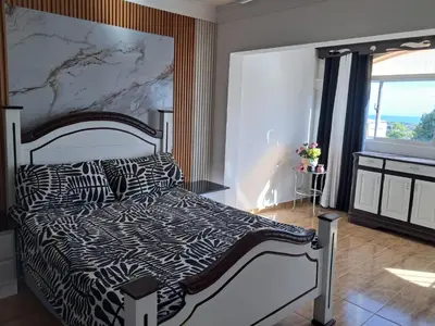 a bedroom with a bed with a black and white comforter at Residencial Jovanny 1 in Colorado