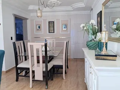 a dining room with a glass table and chairs at Residencial Jovanny 1 in Colorado