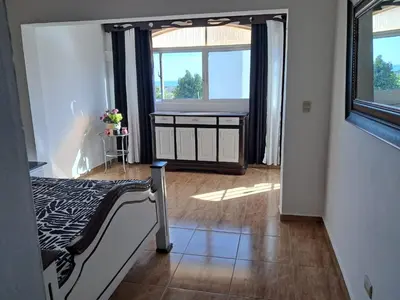a bedroom with a bed and a large window at Residencial Jovanny 1 in Colorado
