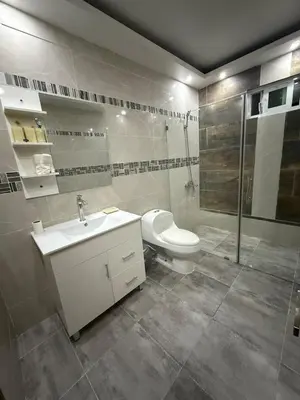 a bathroom with a toilet and a sink and a shower at Modern Getaway with Private Pool, Montecristi in Villa Vásquez