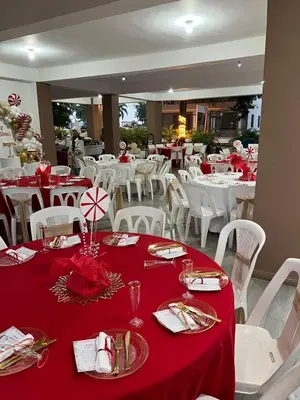a dining room with white tables and red table cloth at Rancho paraíso escondido in San Pedro de Macorís
