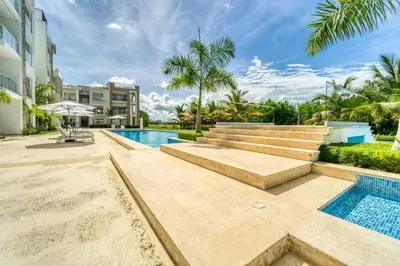 a swimming pool with stairs and a resort at Luxury apartment in hard rock punta cana in Punta Cana