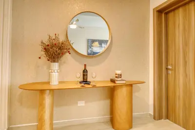 a table with a mirror and a bottle of wine at Luxury apartment in hard rock punta cana in Punta Cana
