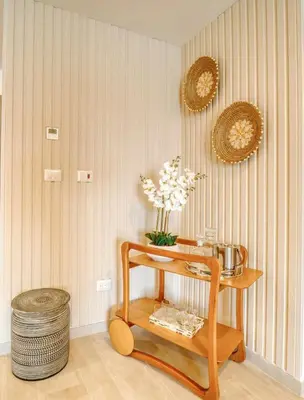 a room with a table with flowers on a wall at Luxury apartment in hard rock punta cana in Punta Cana
