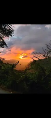 a sunset with the sun setting in the sky at Montaña viva in Sánchez