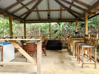 a pavilion with chairs and a table and a grill at Montaña viva in Sánchez