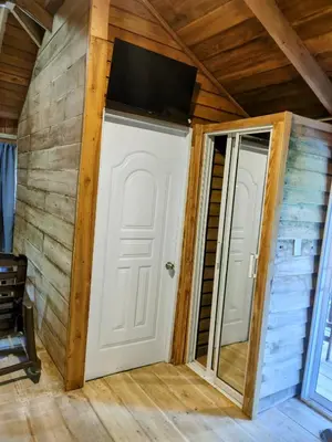 a room with a white door and a flat screen tv at Montaña viva in Sánchez