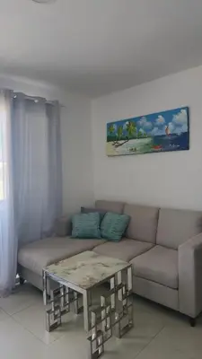 a living room with a couch and a table at Nuevo Apartamento en Bayahibe in Bayahibe