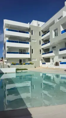 a swimming pool in front of a building at Nuevo Apartamento en Bayahibe in Bayahibe