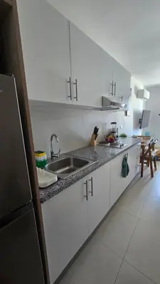 a kitchen with white cabinets and a sink in it at Nuevo Apartamento en Bayahibe in Bayahibe