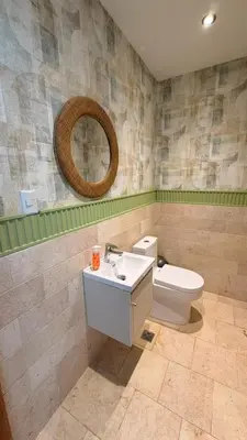 a bathroom with a toilet and a sink and a mirror at Family Friendly Beach Apartment in Juan Dolio in Los Corrales