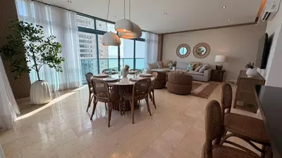 a living room with a table and chairs and a couch at Family Friendly Beach Apartment in Juan Dolio in Los Corrales