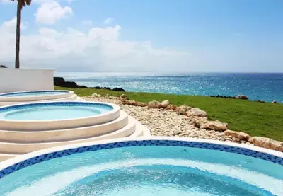 two swimming pools with the ocean in the background at Bubble Glamping, King bed, we have a 8 units like this in Sosúa