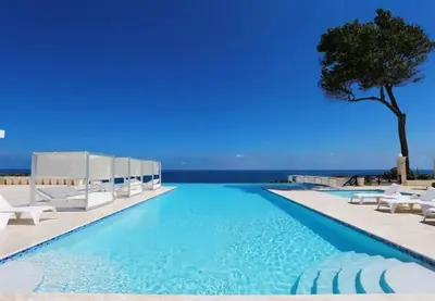 a pool with chairs and a tree and the ocean at Bubble Glamping, Family 2 beds, we have a 12 units like this in Sosúa