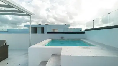 a swimming pool in the middle of a house at Ático ONA White Sands | Terraza & Picuzzi privado in Punta Cana