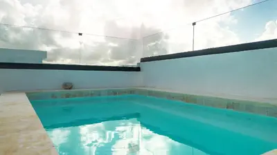 a swimming pool with blue water in a room at Ático ONA White Sands | Terraza & Picuzzi privado in Punta Cana