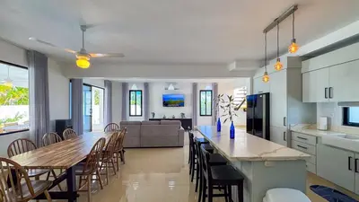 a kitchen and dining room with a long table and chairs at Sosua Ocean Village - Villas Marinas 27B in Sosúa