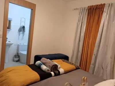 a bedroom with two beds and a mirror at Elton de Gurabo es tu lugar in Santiago de los Caballeros