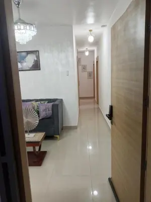 a hallway leading to a living room with a couch at Elton de Gurabo es tu lugar in Santiago de los Caballeros