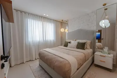 a bedroom with a large bed with white curtains at Luxstay SDQ in Santo Domingo