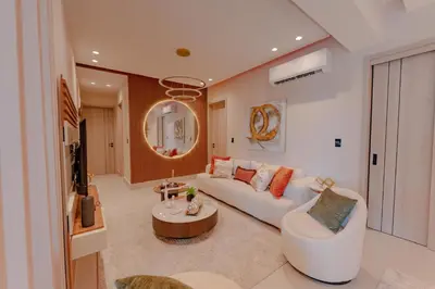 a living room with a white couch and a table at Luxstay SDQ in Santo Domingo