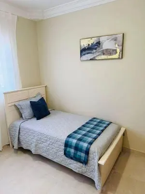 a bedroom with a bed with a plaid blanket on it at Punta Cana Apartment Tropical Escape near Beach in Punta Cana