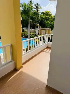 a balcony with a view of a swimming pool at Punta Cana Apartment Tropical Escape near Beach in Punta Cana