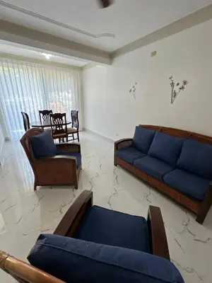 a living room with blue couches and chairs at Cabarete Town House in Cabarete