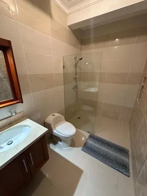 a bathroom with a shower and a toilet and a sink at Cabarete Town House in Cabarete