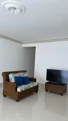 a living room with a couch and a flat screen tv at Cabarete Town House in Cabarete