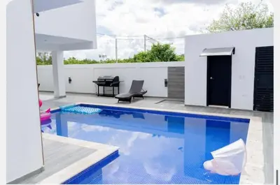 a swimming pool in the middle of a house at Villa Joa in Punta Cana