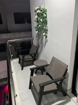 two chairs and a table with a plant hanging from a wall at Villa Joa in Punta Cana