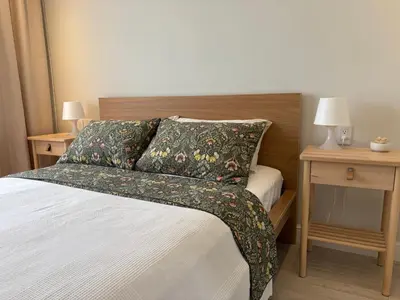a bedroom with a bed and two tables with lamps at 2Bedroom Apt Pool Beach Restaurants in Punta Cana