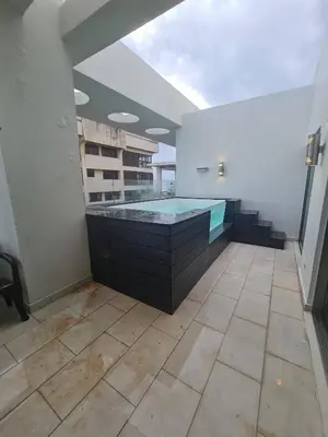 a large swimming pool in the middle of a room at Miraculus Penthouse With Private Jacuzzi in Santo Domingo
