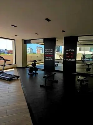 a gym with a teddy bear sitting on the floor at Miraculus Penthouse With Private Jacuzzi in Santo Domingo
